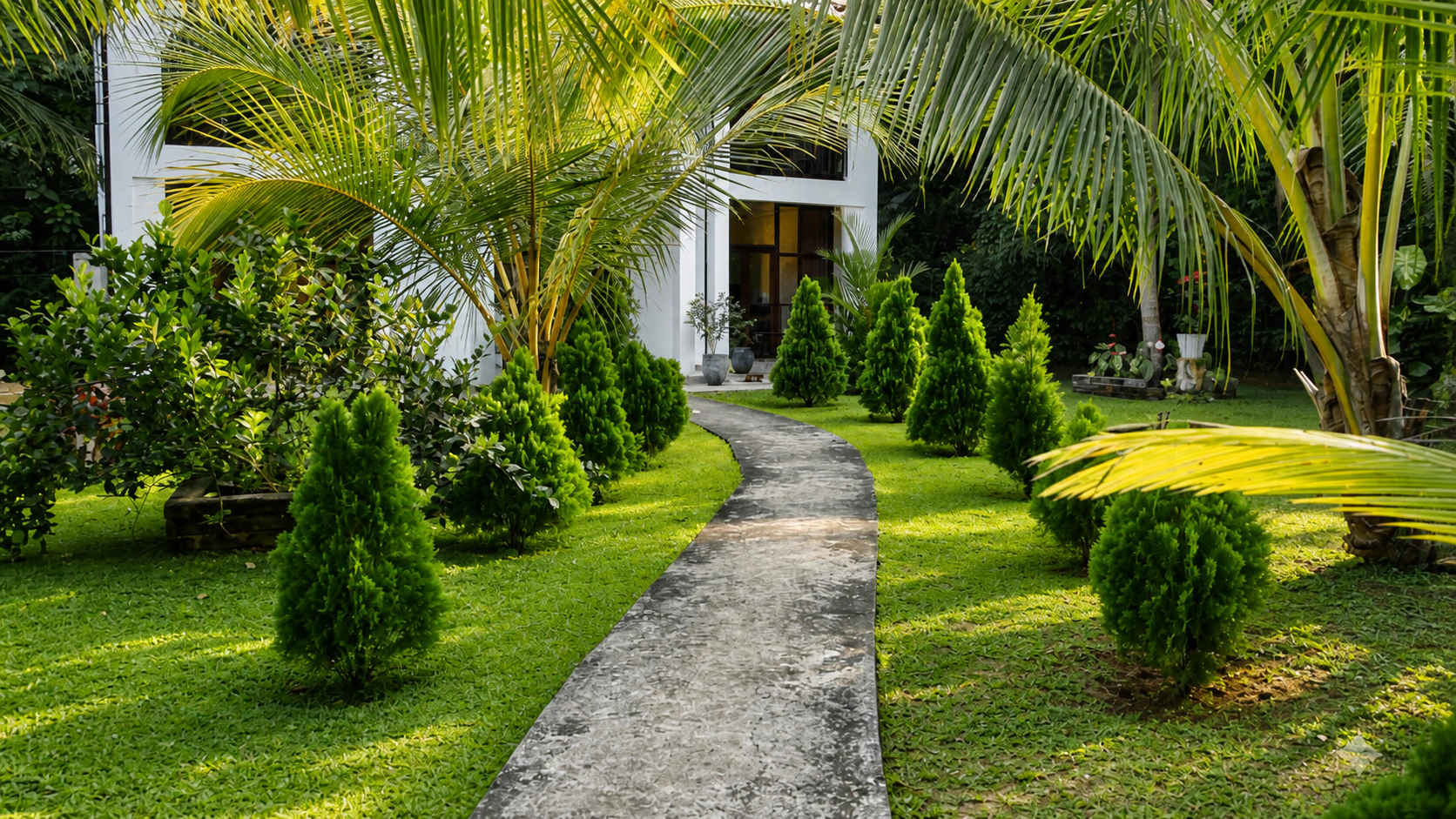 A guest walking through the tropical garden