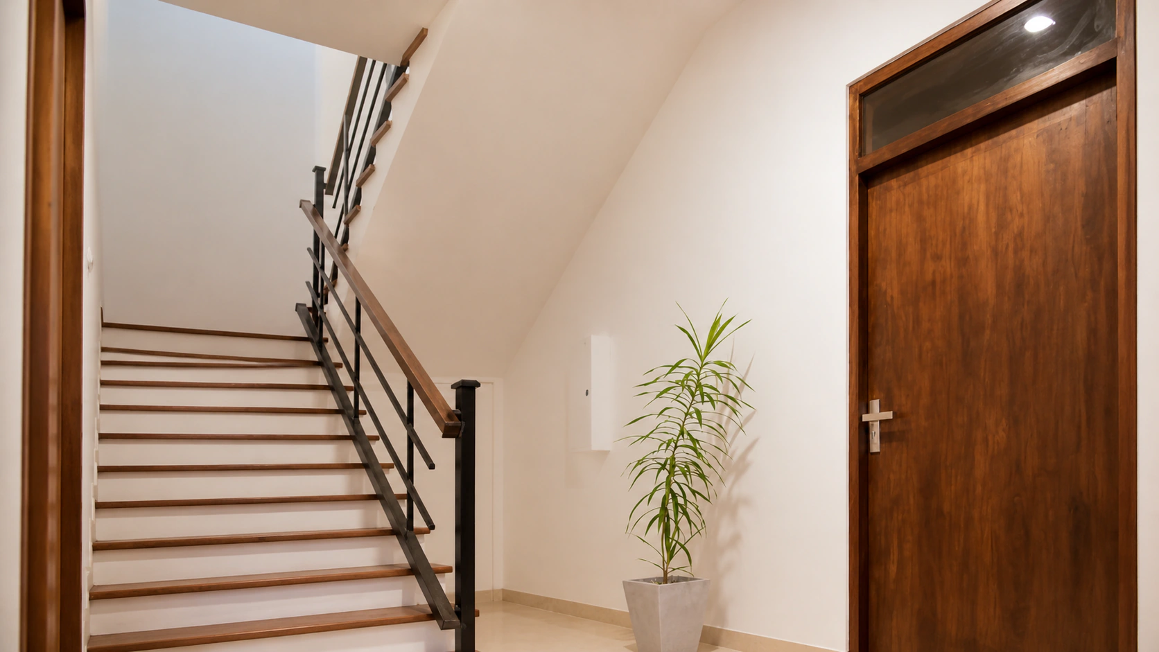 The bright timber staircase inside Manike Lodge